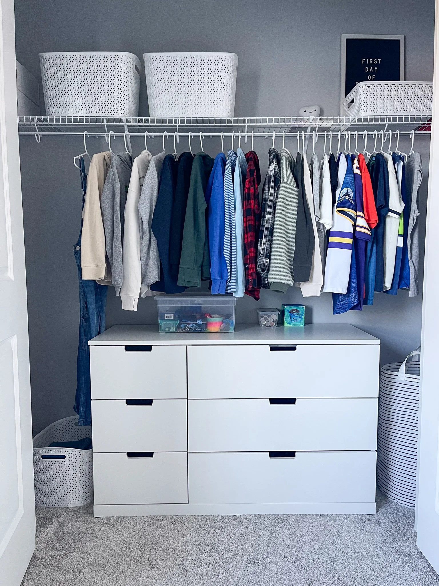 Kids closet organized with functional hanging and drawer storage