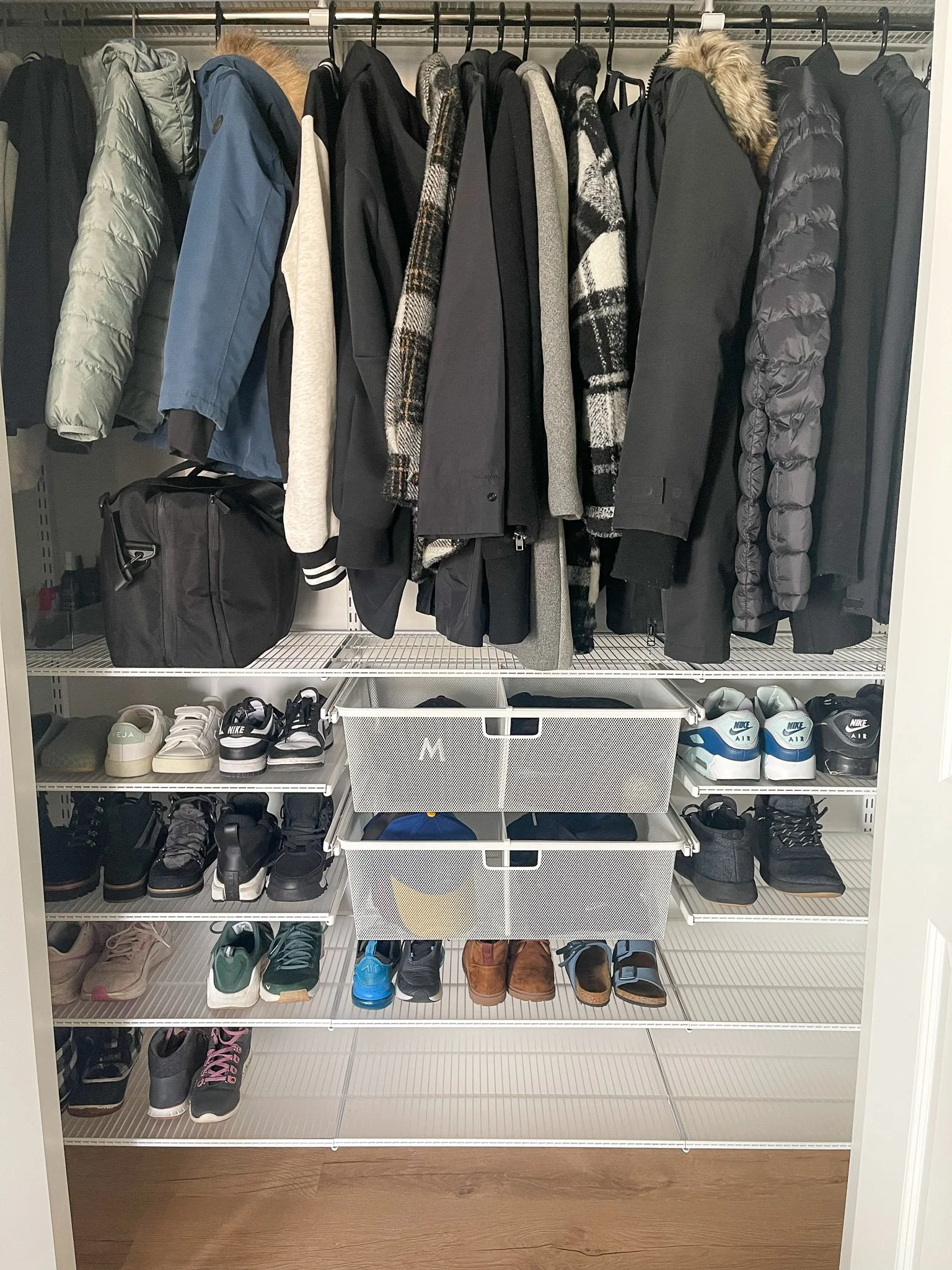 Entry closet organized with a custom storage system