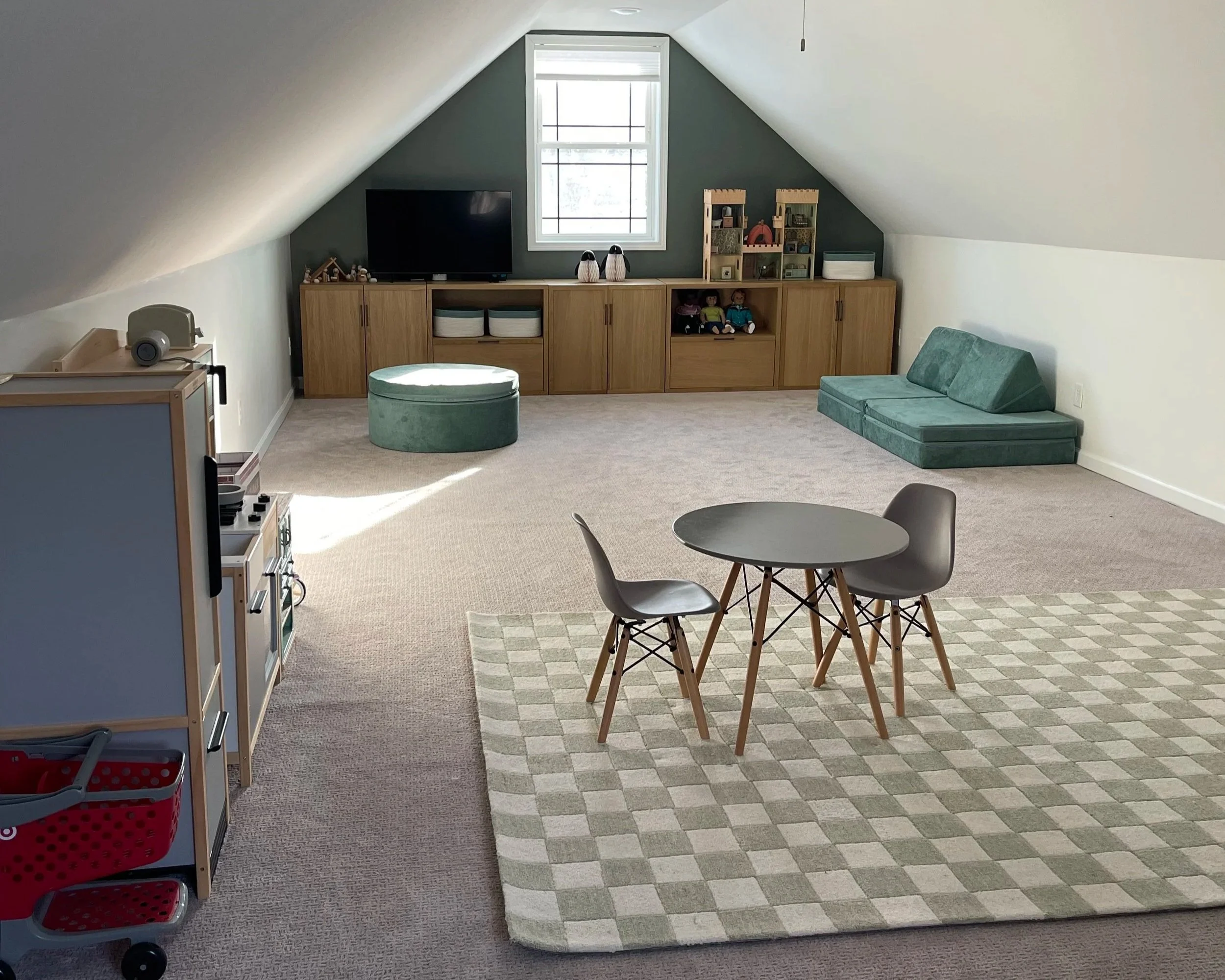 Organized children's playroom with functional toy storage and designated spaces for toys, books, and activities.
