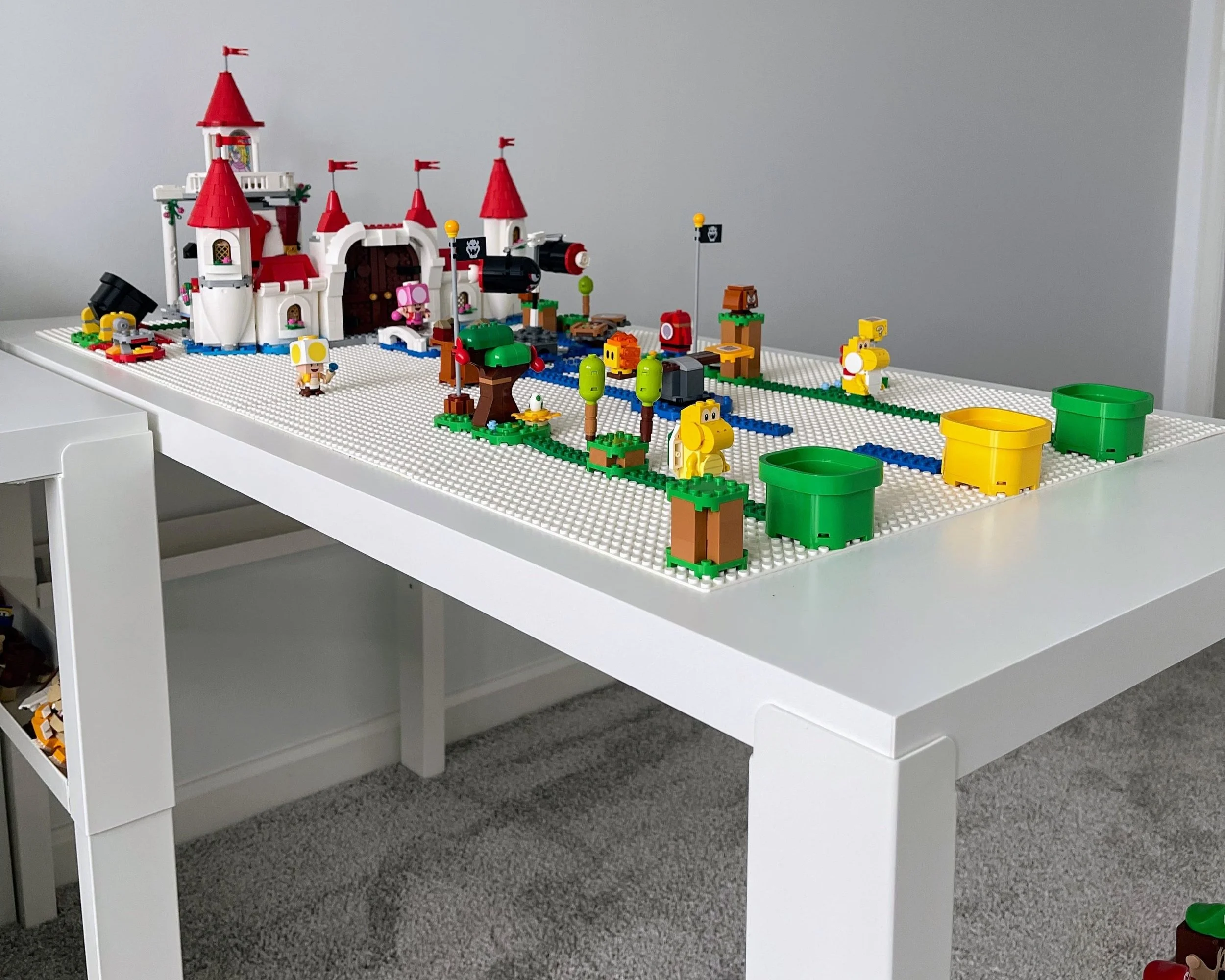Dedicated LEGO building desk with adjustable IKEA PÅHL desk and baseplates for creative play.