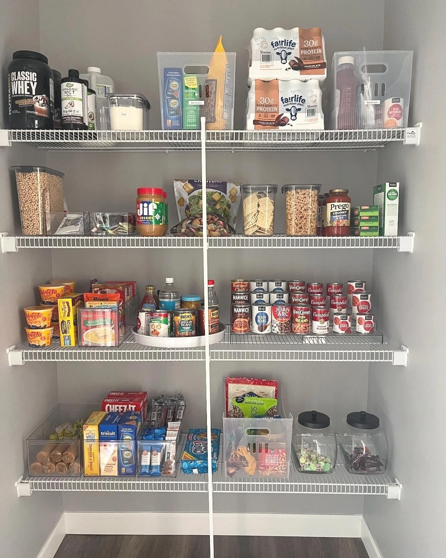 Multi-purpose bins used to organize backstock food items in a pantry after buying in bulk.