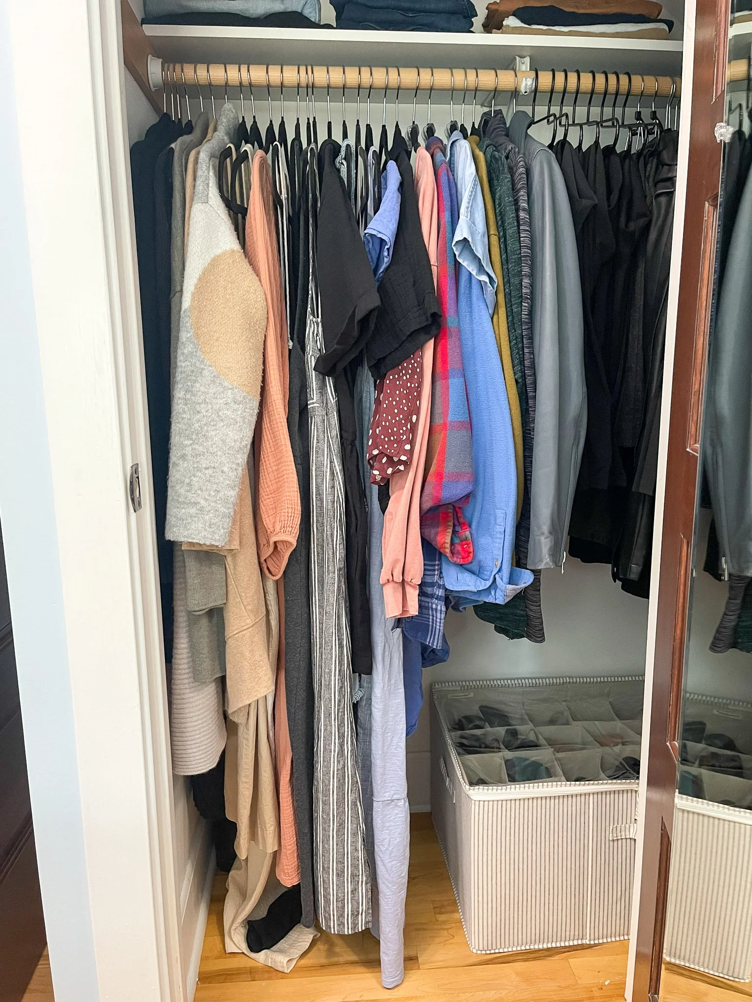 Small women’s closet organized for efficient hanging storage