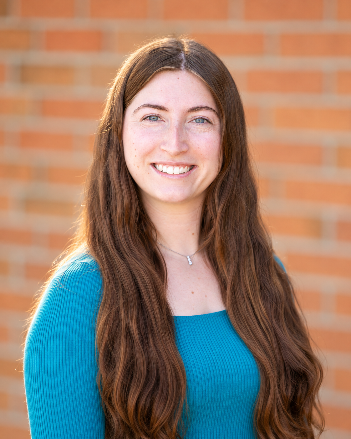 woman with long brown hair smiling