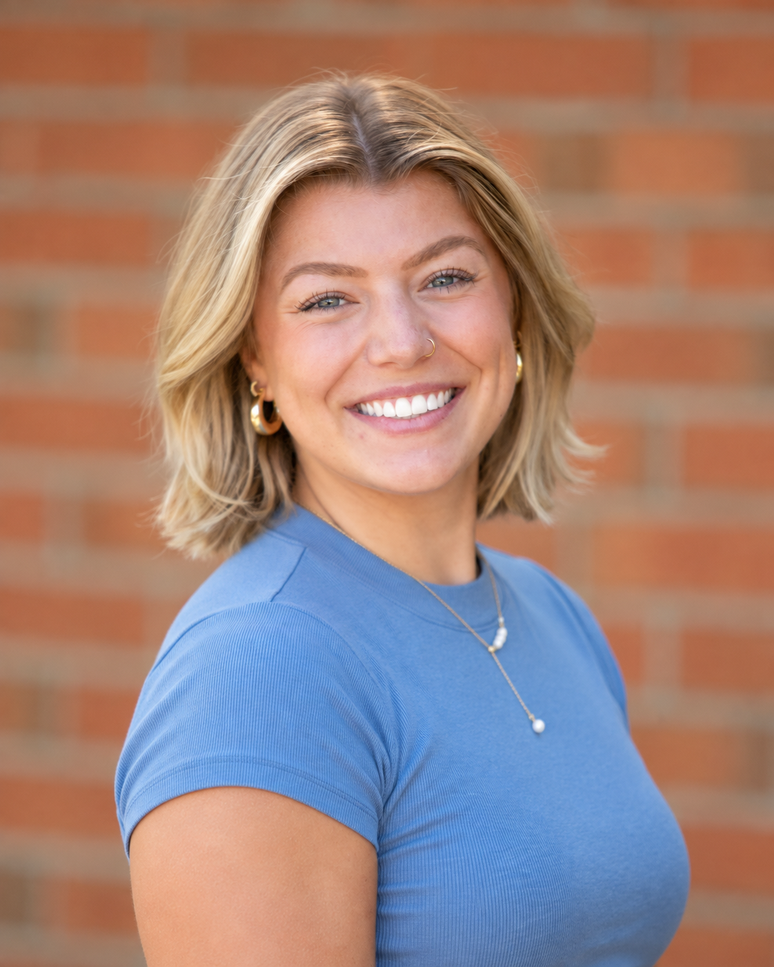 woman with short blond hair smiling