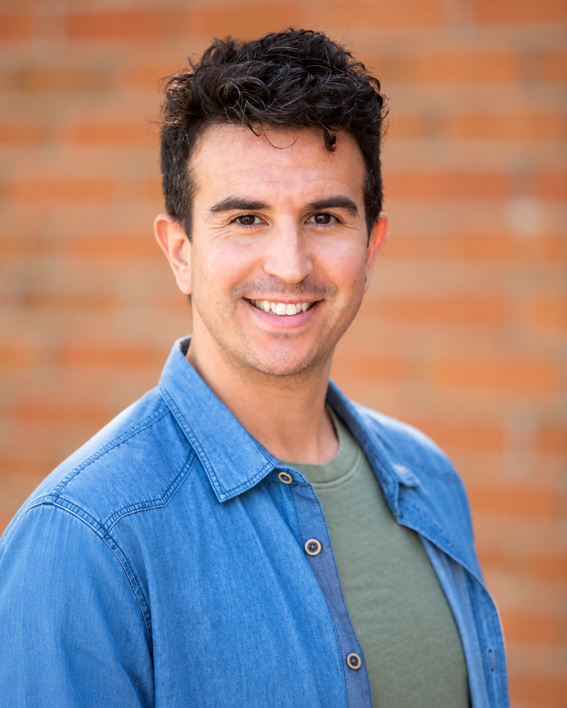 a man looks at the camera smiling