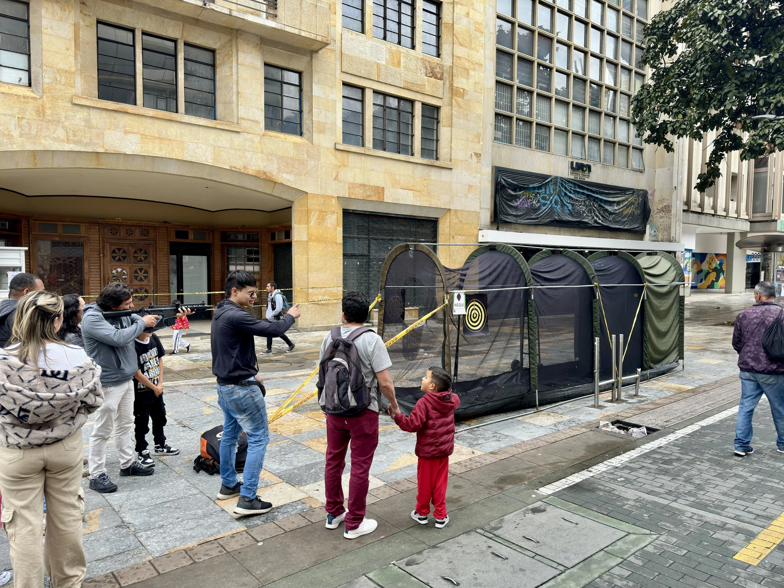 they are trying painball gun with 1,000 people around them. Police was right bahind them ...