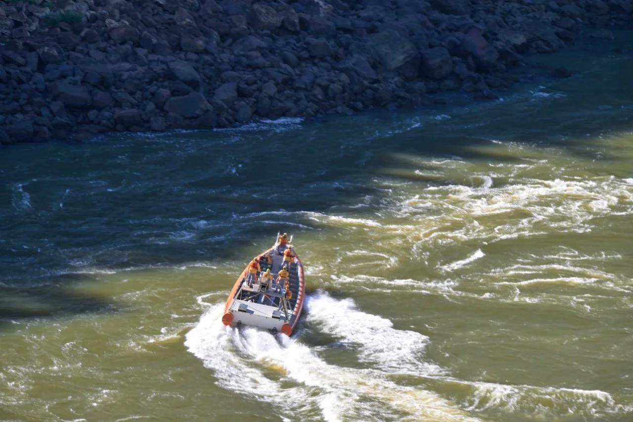 Brazilian official checking out the river for obstacles because of extremely low water level