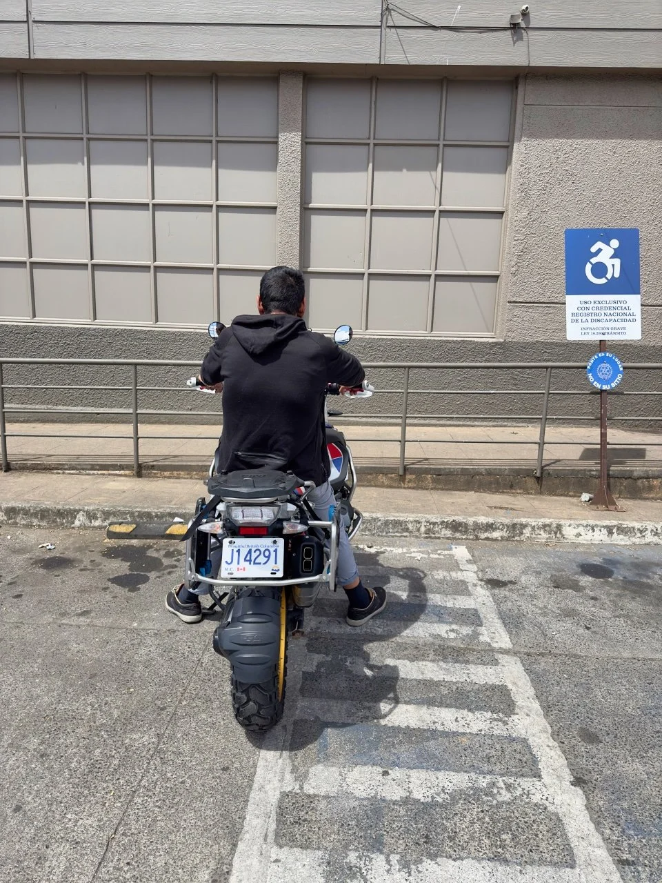  a random guy sitting on my motorcycle outside the supermarket