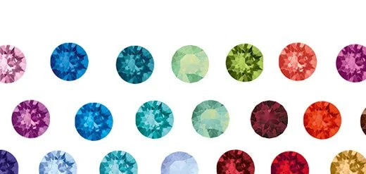 Multiple colorful round gemstones arranged in rows.