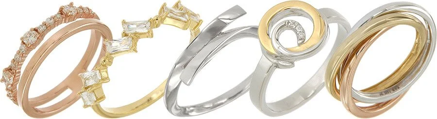 A collection of six intertwined rings in various gold and silver tones, some adorned with diamonds or decorative elements.