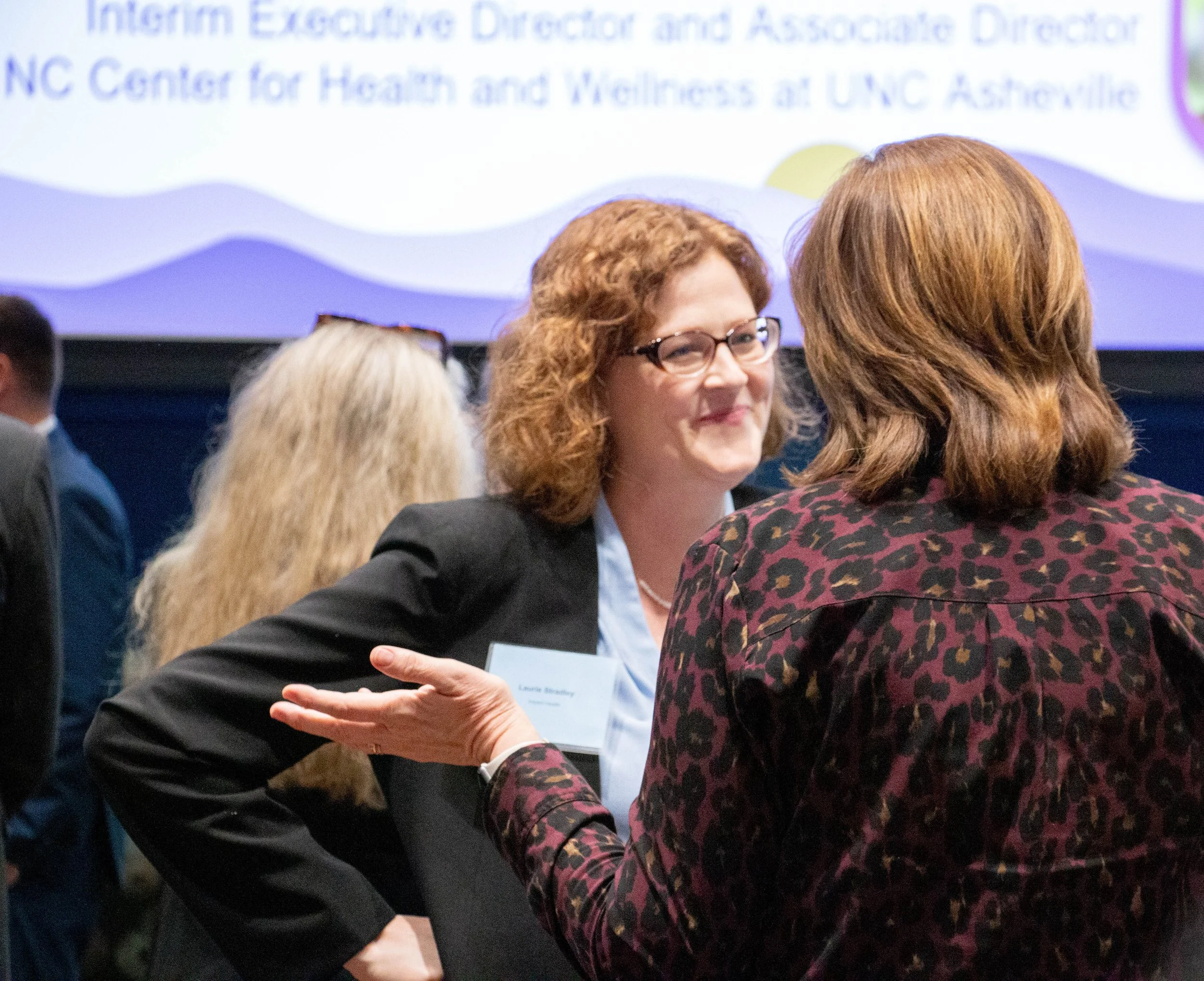 Laurie Stradley speaks with attendees. Photo credit: Michaela Lumpert, Impact Health