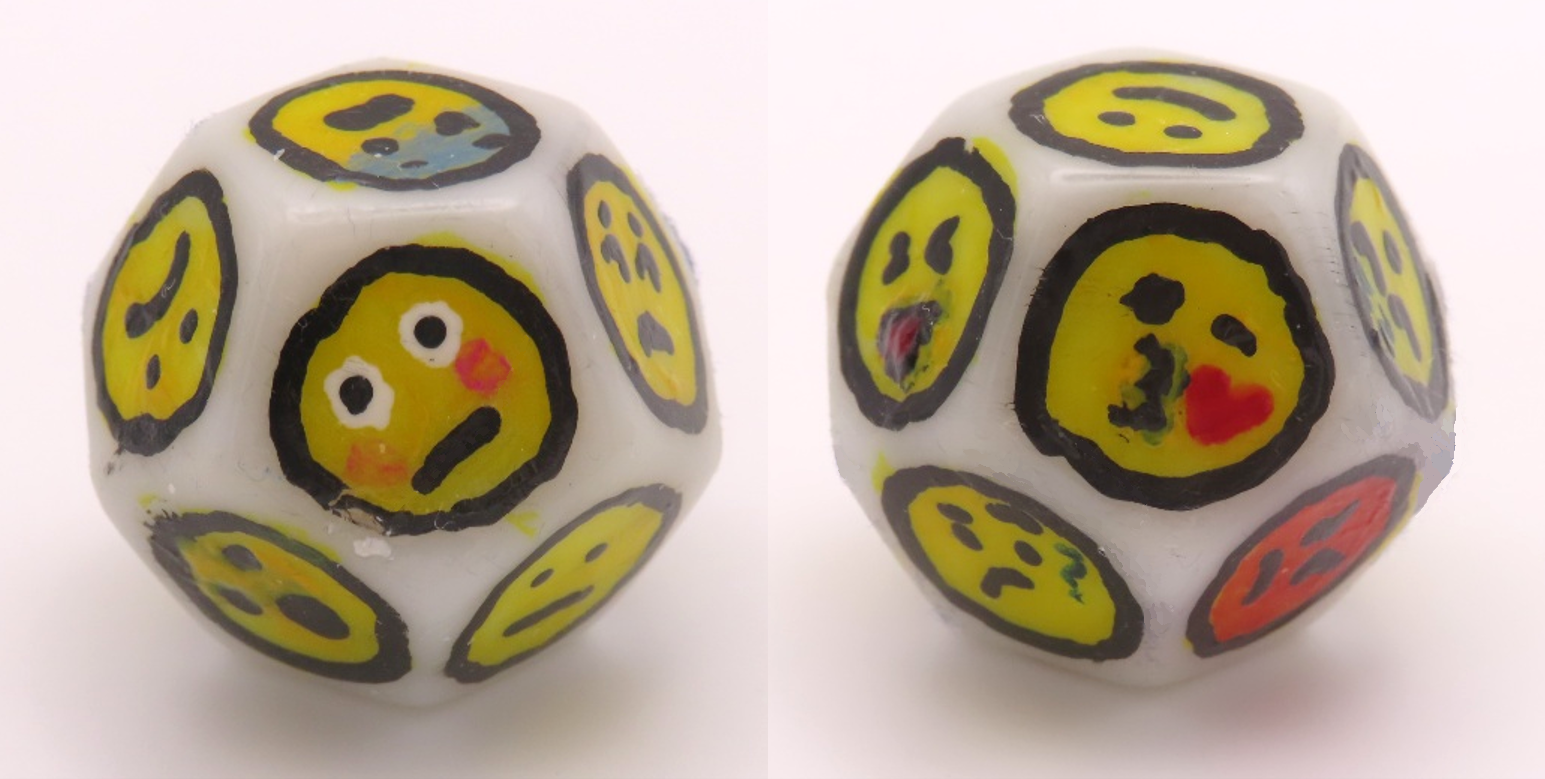 Two images of a twelve-sided die, each face painted with a different emoji, such as embarrassed, scared, happy or flirtatious