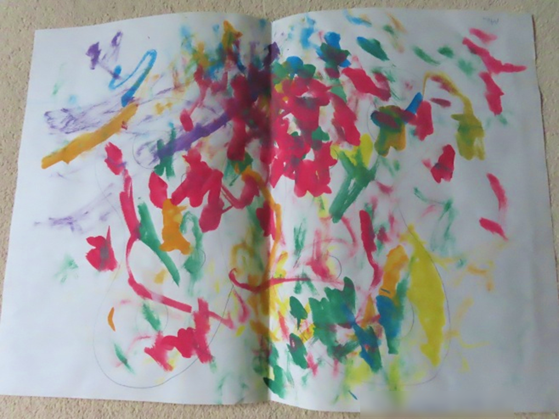A child's painting of multicoloured blobs with the faint outline of a butterfly underneath