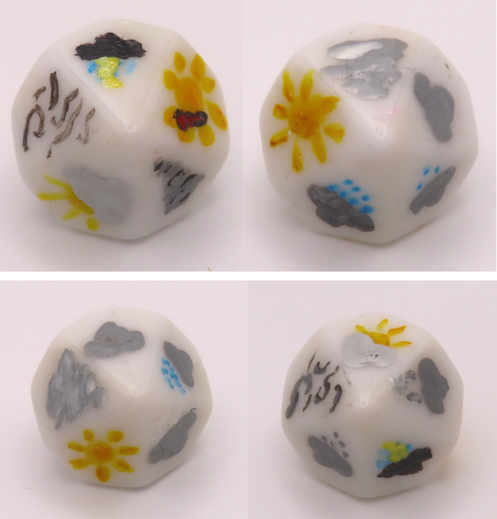 Four images of two ten-sided dice, each face painted with a symbol to represent a kind of weather, such as sun, rain, wind or fog