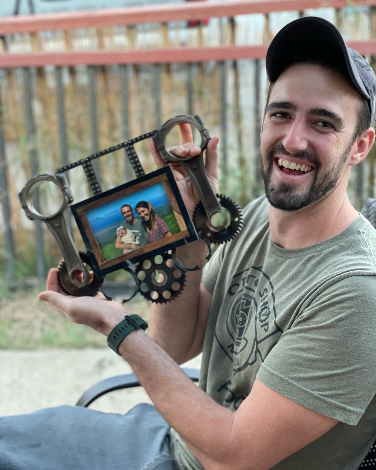 Otto Arnesen holding a picture frame made from engine parts