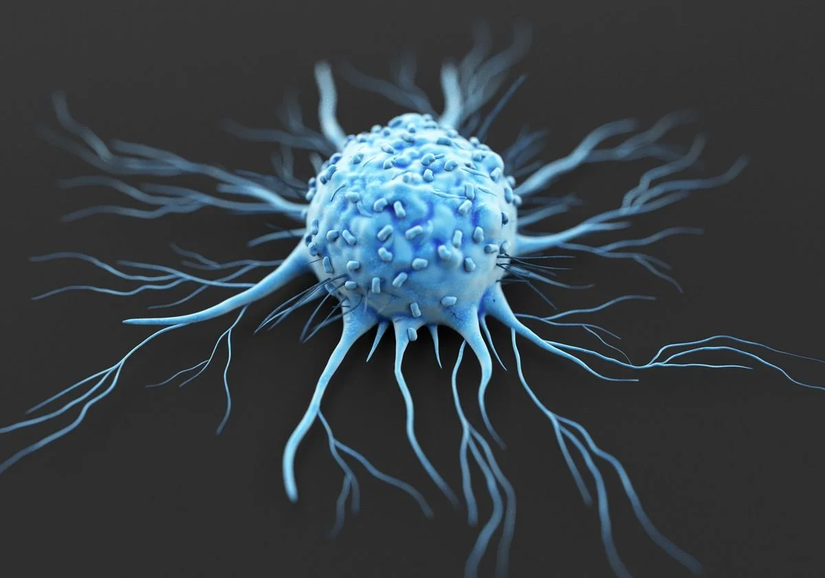 3D rendering of a cancer cell with extending tentacles on a dark background.