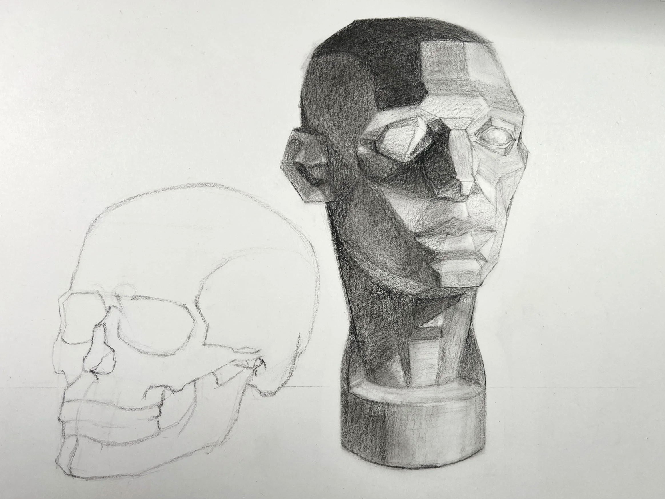 A pencil drawing of a human skull on the left and a geometric bust sculpture of a human head on a cylindrical pedestal on the right.