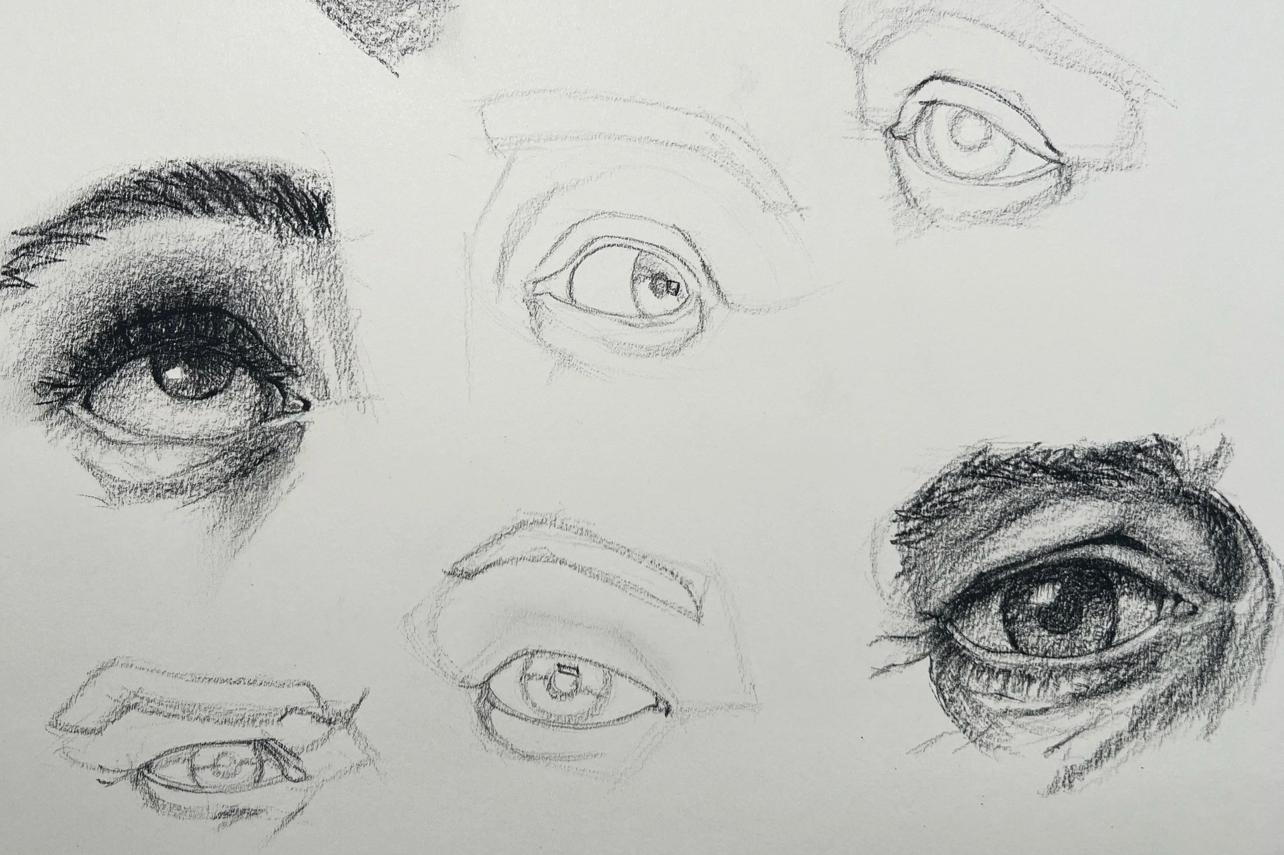 Collection of pencil sketches of different human eyes and eyebrows in various styles and angles.