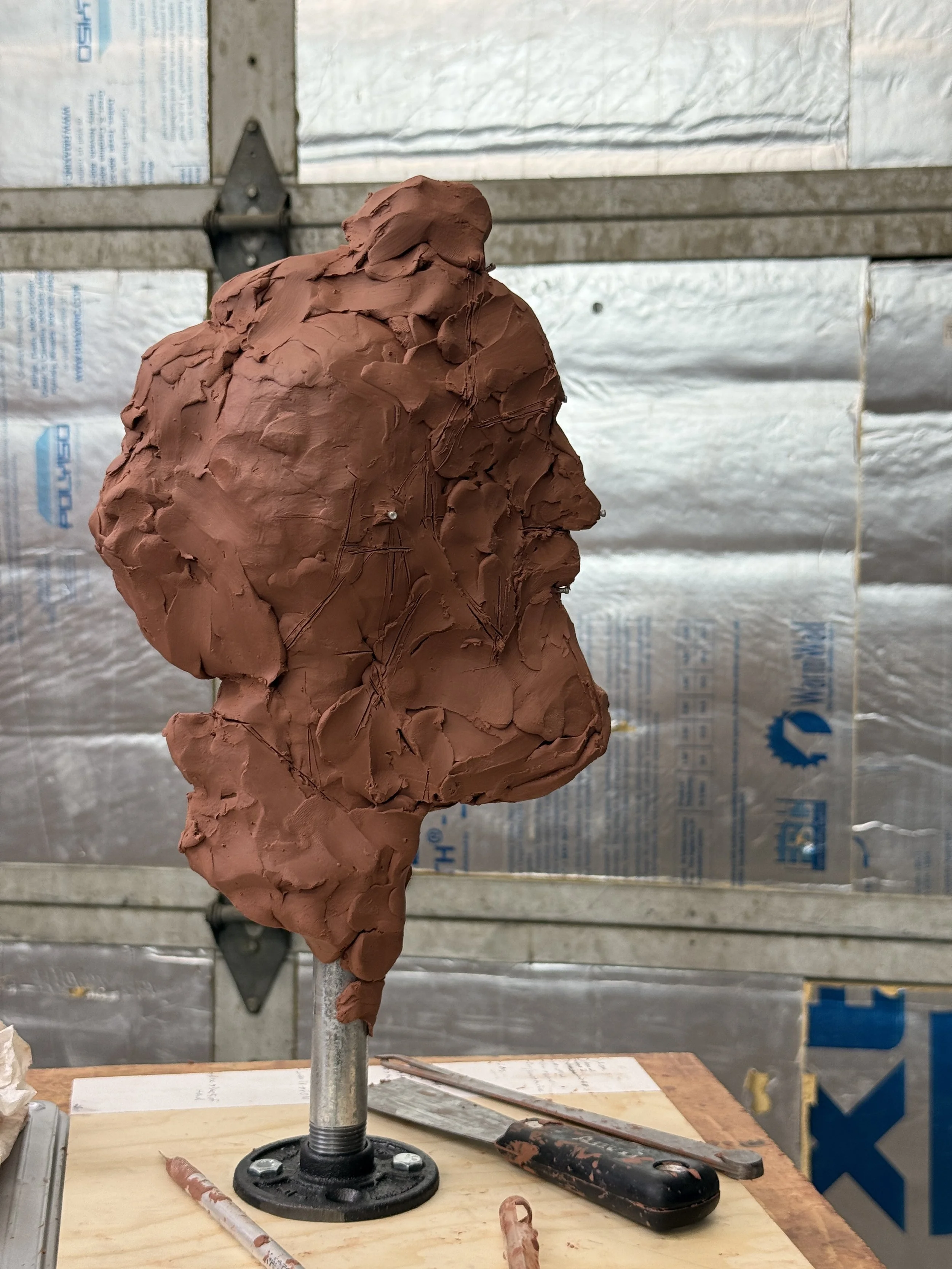 The beginning steps of a clay portrait sculpture.