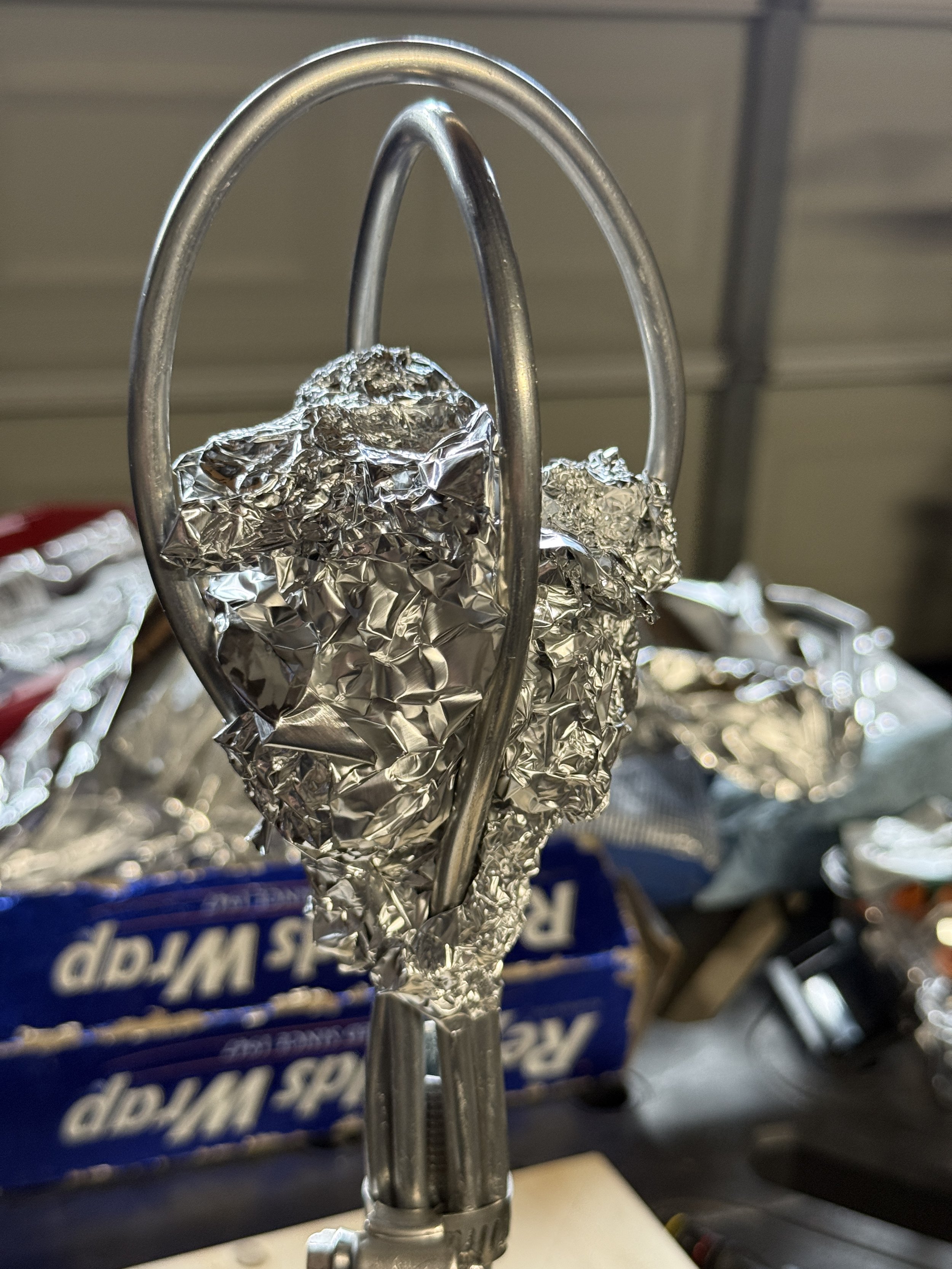 Foil paper being added to an armature for a head sculpture
