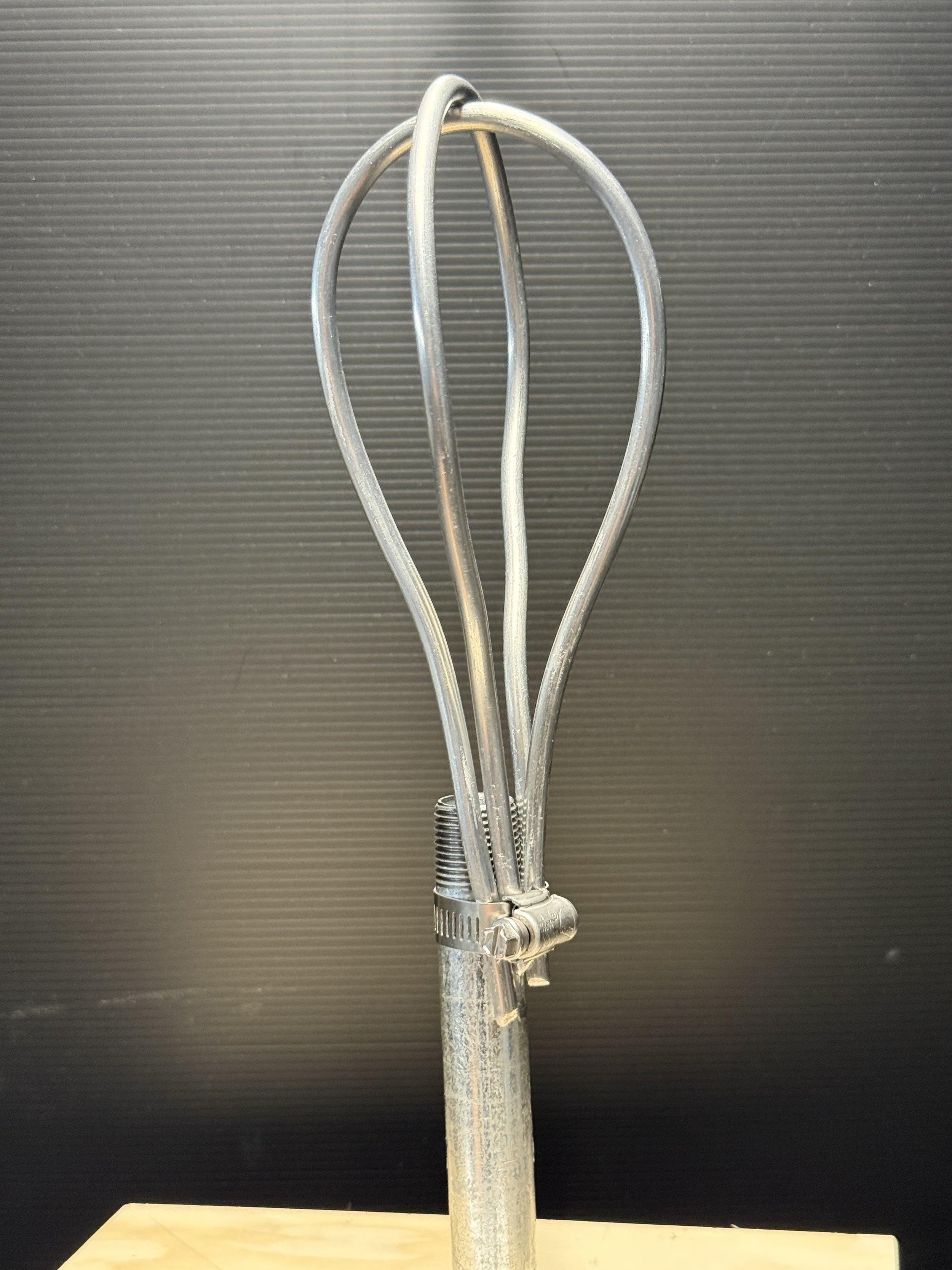 Armature wire mounted to a metal pipe using hose clamp