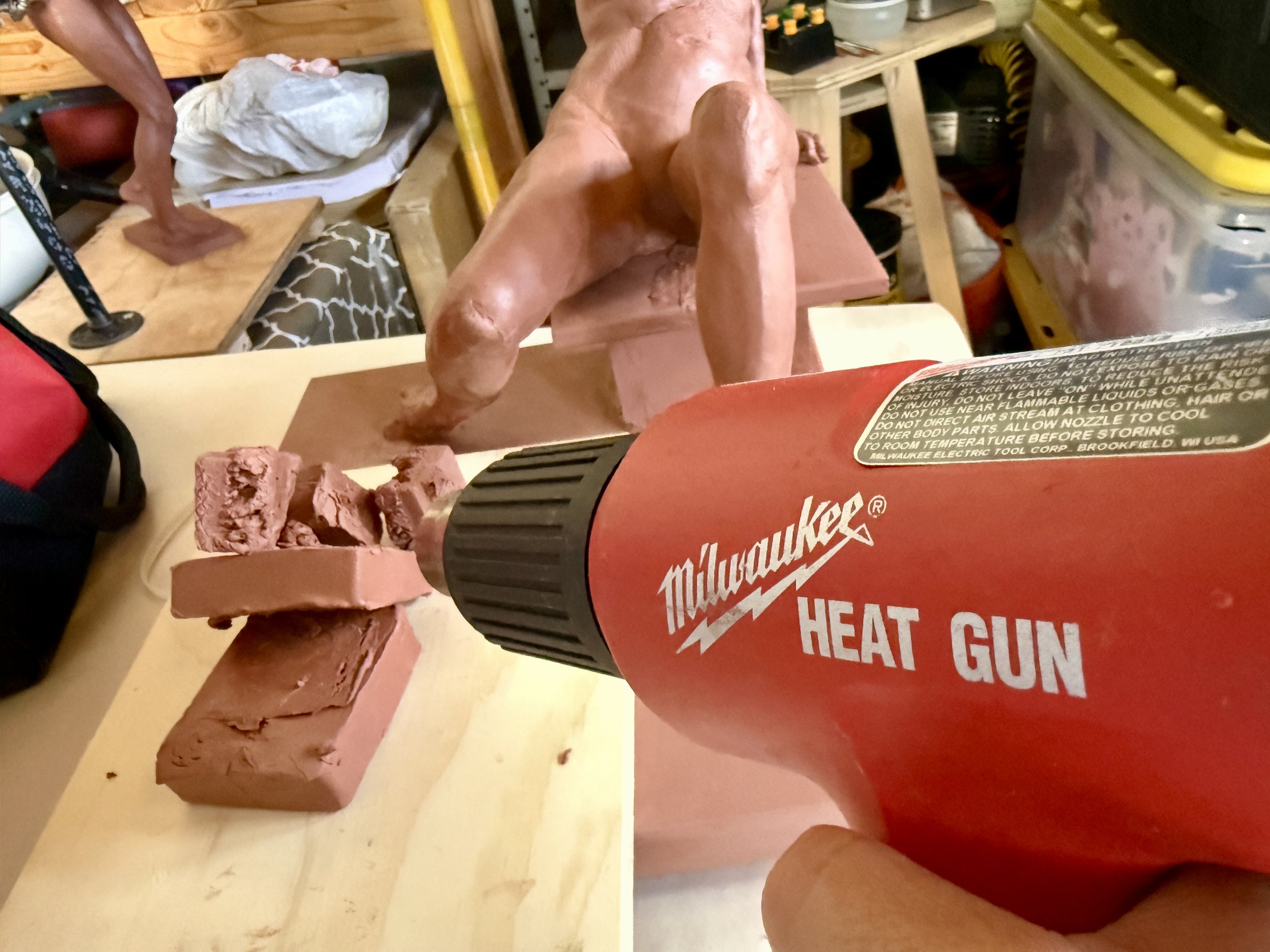 Oil based clay being warmed up with a heat gun