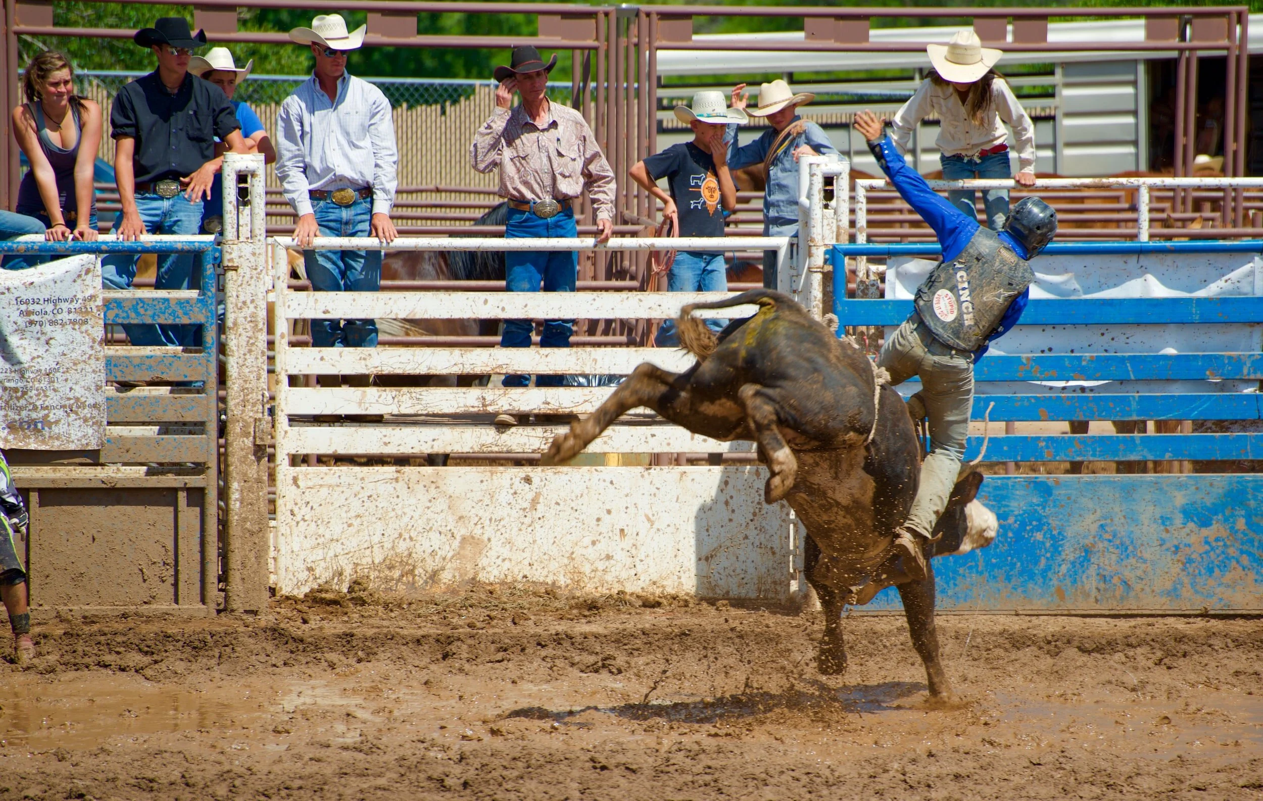 Cowboy riding a bucking horse at the PRCA Rodeo in Hugo, OK