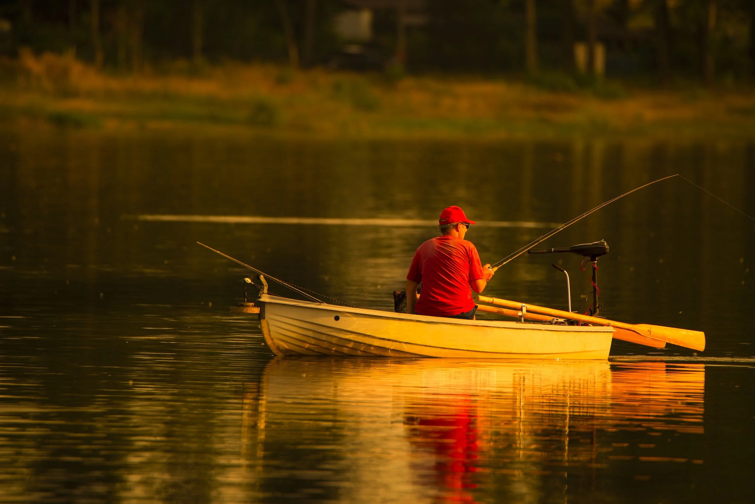 Fisherman fishing at dusk on Pat Mayse Lake