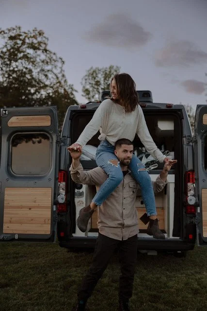 J and J photographers Jeremy and Jodi | outside camper with Jodie on Jeremy's shoulders