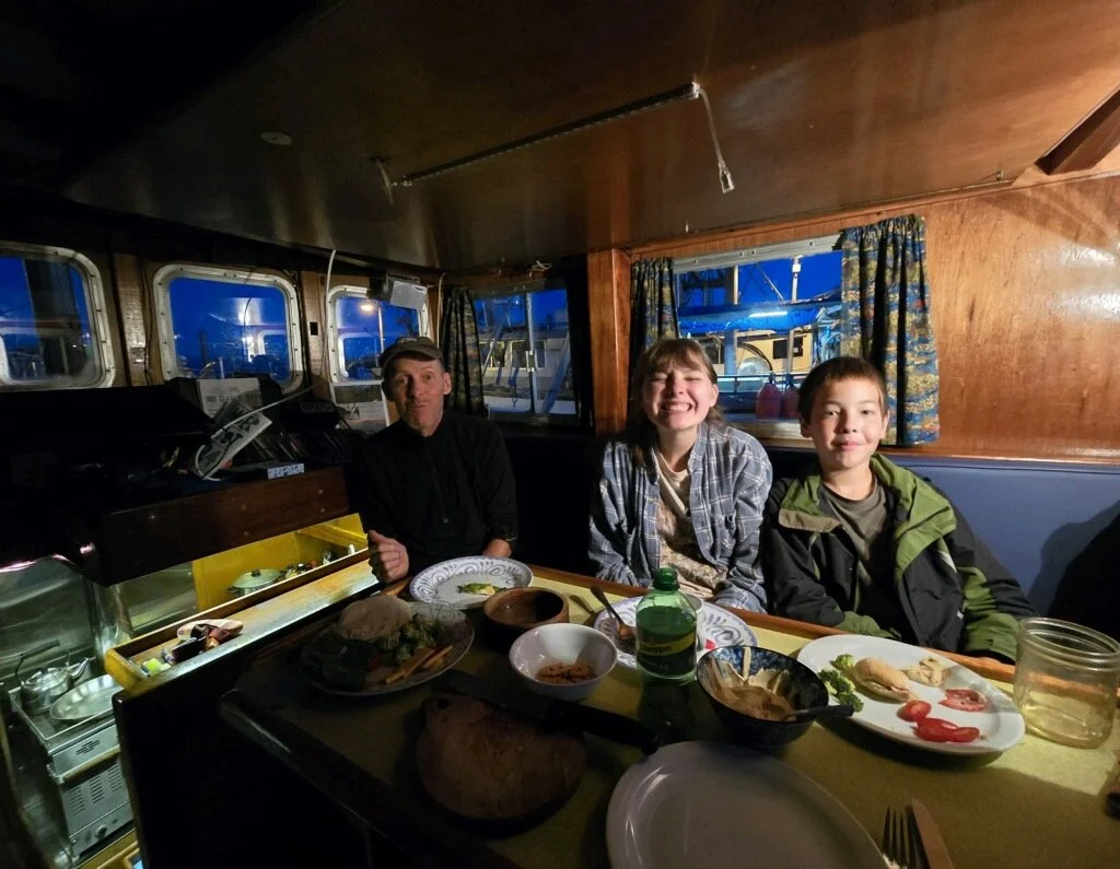 Family enjoying dinner on the boat.