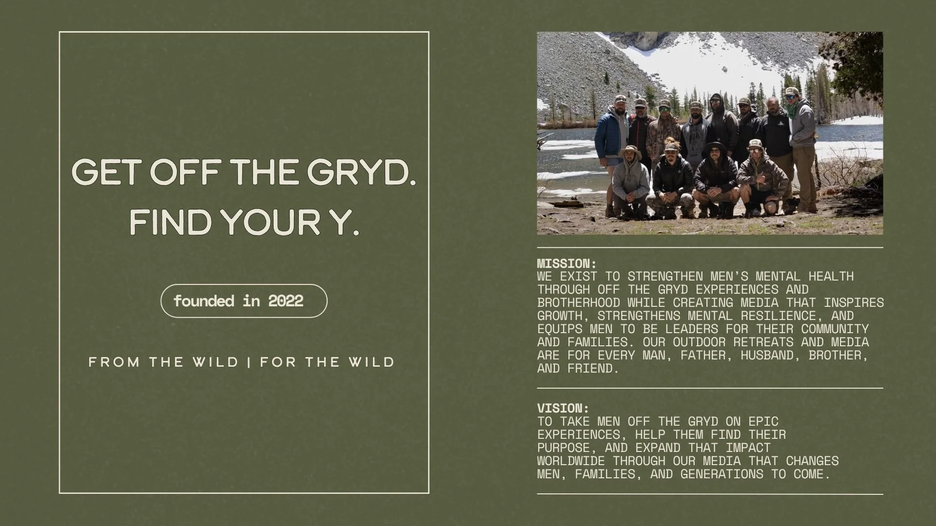 Group of men outdoors near a lake with snowy mountains in the background, dressed for cold weather.
