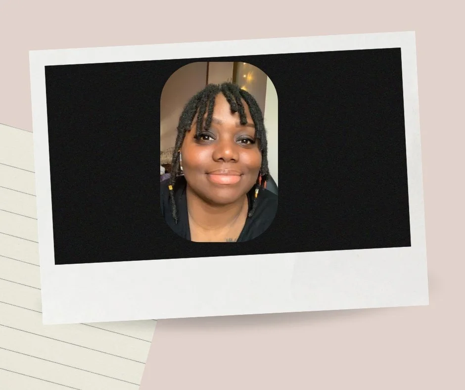 A woman with short dreadlocks smiling in a portrait photo within a Polaroid frame, resting on a pastel pink background.