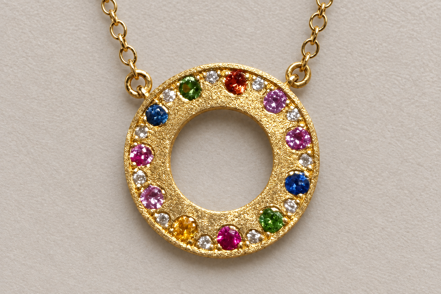 Gold pendant with multicolored gemstones on a gold chain