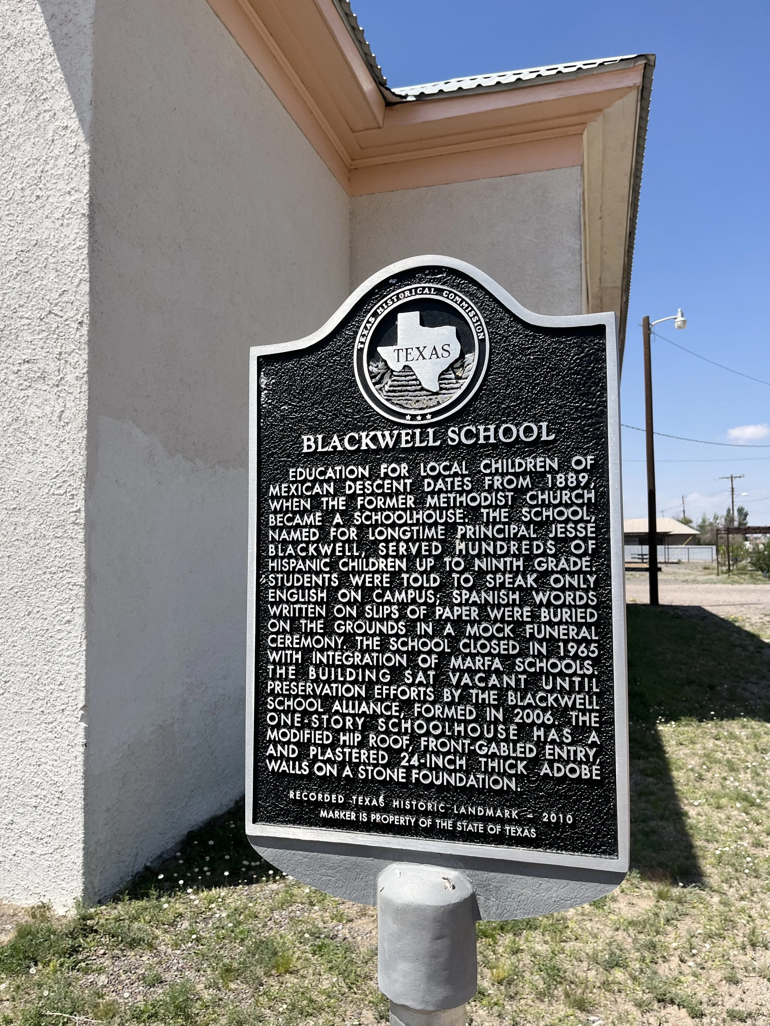 Historical marker sign about Blackwell School in Texas, detailing its history as a school for Mexican descent children, its role as a former Methodist church, and restoration efforts.