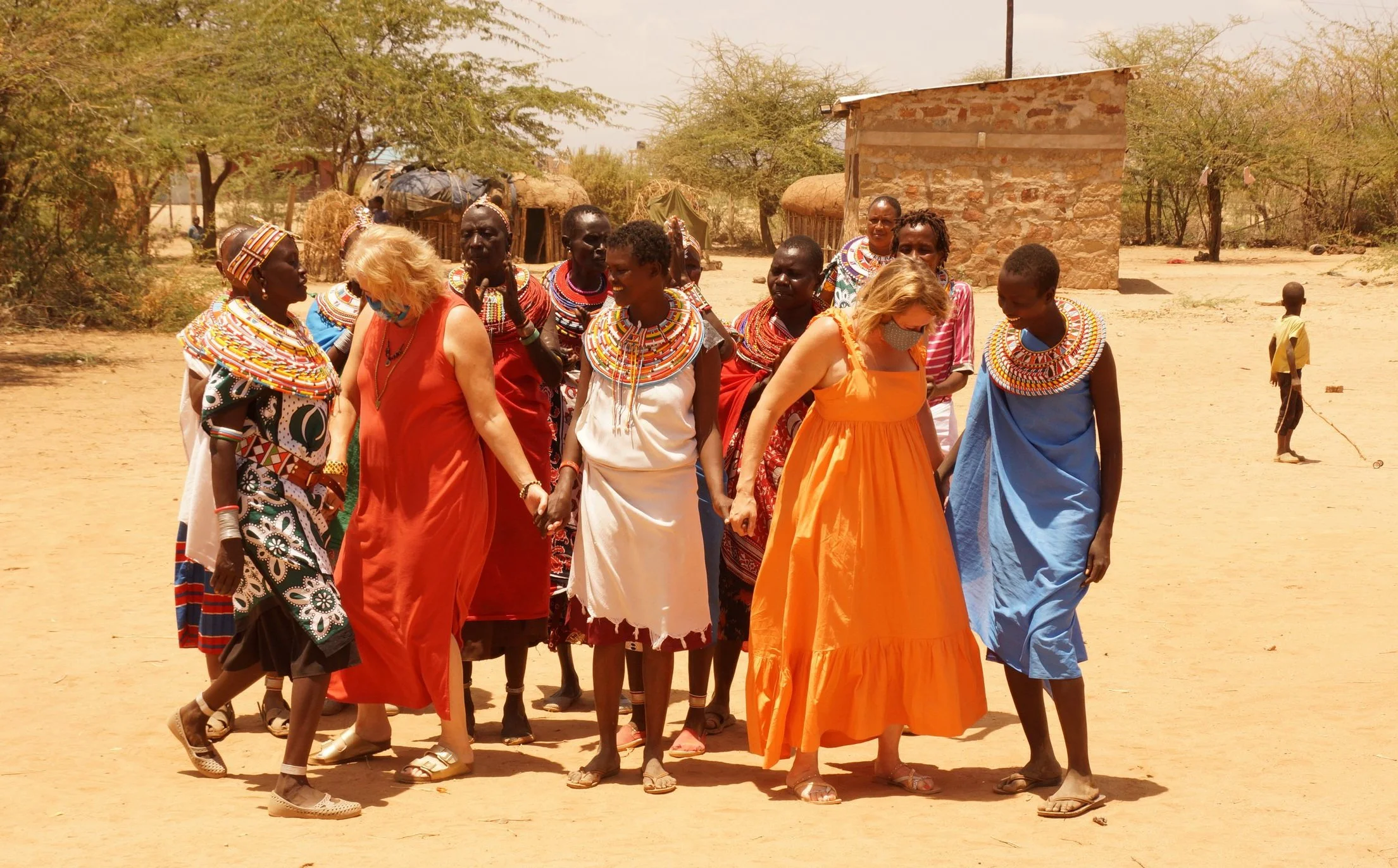 Robin dancing with the women of …