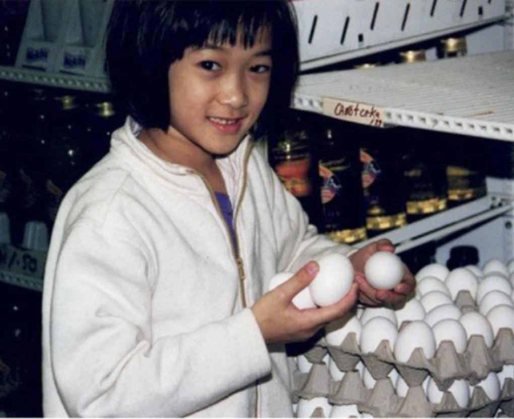 A young Dorothy Chow holding three eggs