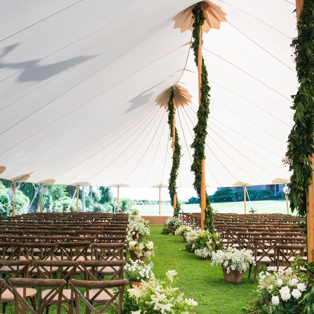 Captivated by @mccoyseventprofessionals' Sperry Tent magic! Imagine your wedding ceremony under this dreamy tent, adorned with florals for a summertime beachside vibe. It's the perfect setup for saying 'I do'! ✨ Let this inspire your next event or we