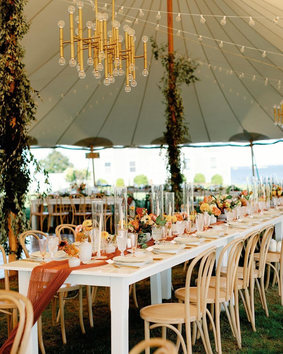Delving into the exquisite decor details under @sperrytents, where floral arrangements bloom with a vibrant summer color palette, adorning table setups that enchant the senses. Let this artistic display inspire your next event or wedding with its cap