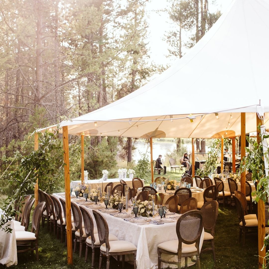 A wedding straight out of a fairytale ✨🌲 Nestled in the heart of nature, this stunning reception is a perfect blend of elegance and the great outdoors. Under the gentle canopy of sailcloth tent, the intimate setting of rustic chairs and delicate flo