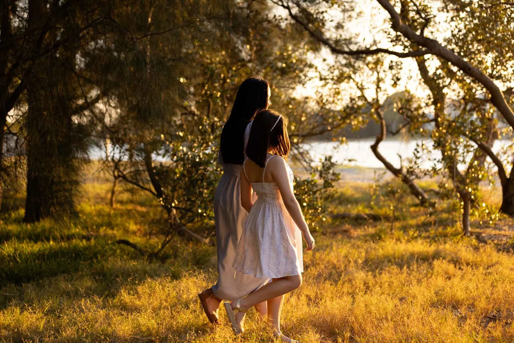 Family photographer Sydney North shore mum and daughter walking in the sunset