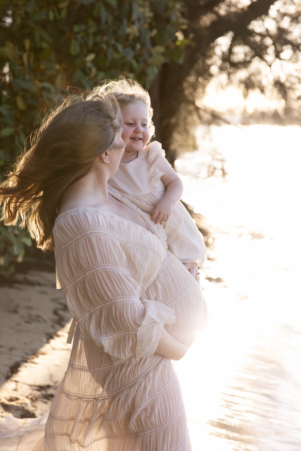 North Shore Maternity photographer, pregnant mother playing in the water with her toddler
