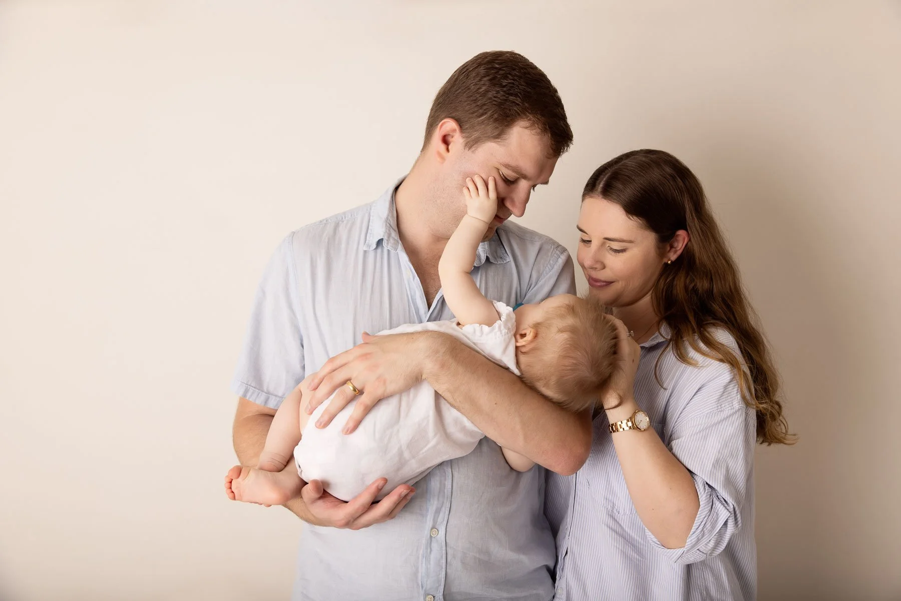 Family photographer Sydney North Shore parents holding their baby
