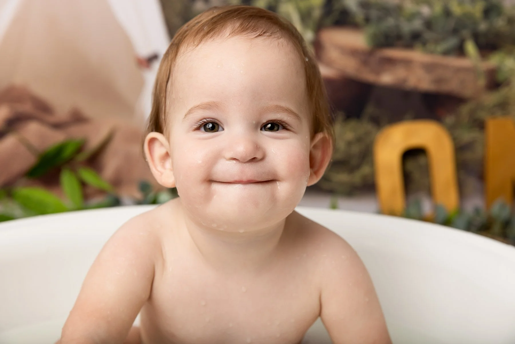 Cake smash photographer Sydney North Shore baby smiling having a bath