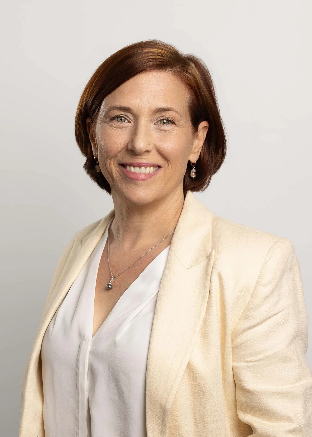 Noemie Vonthron Photography headshots Sydney corporate headshot of a woman wearing a light yellow jacket
