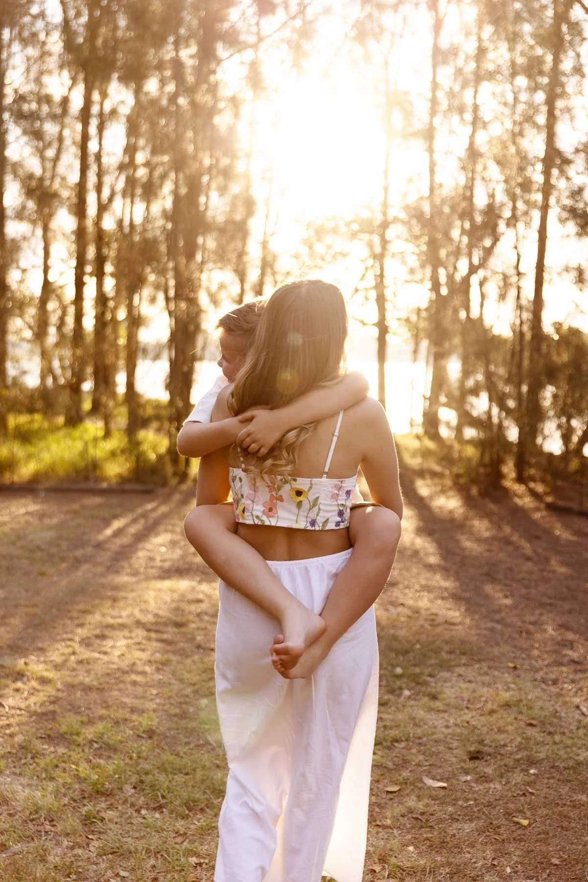 Family photographer Sydney North shore mum and son walking in the sunset