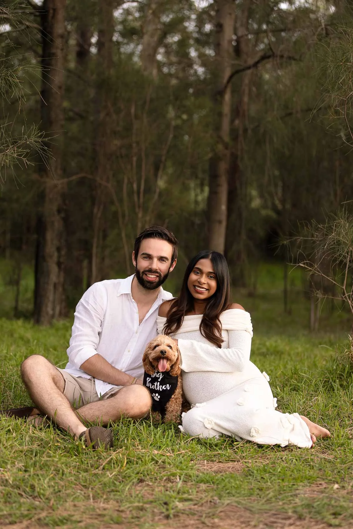 Pregnant woman, her husband and dog in white dress in the wood at sunset North Shore Maternity photographer