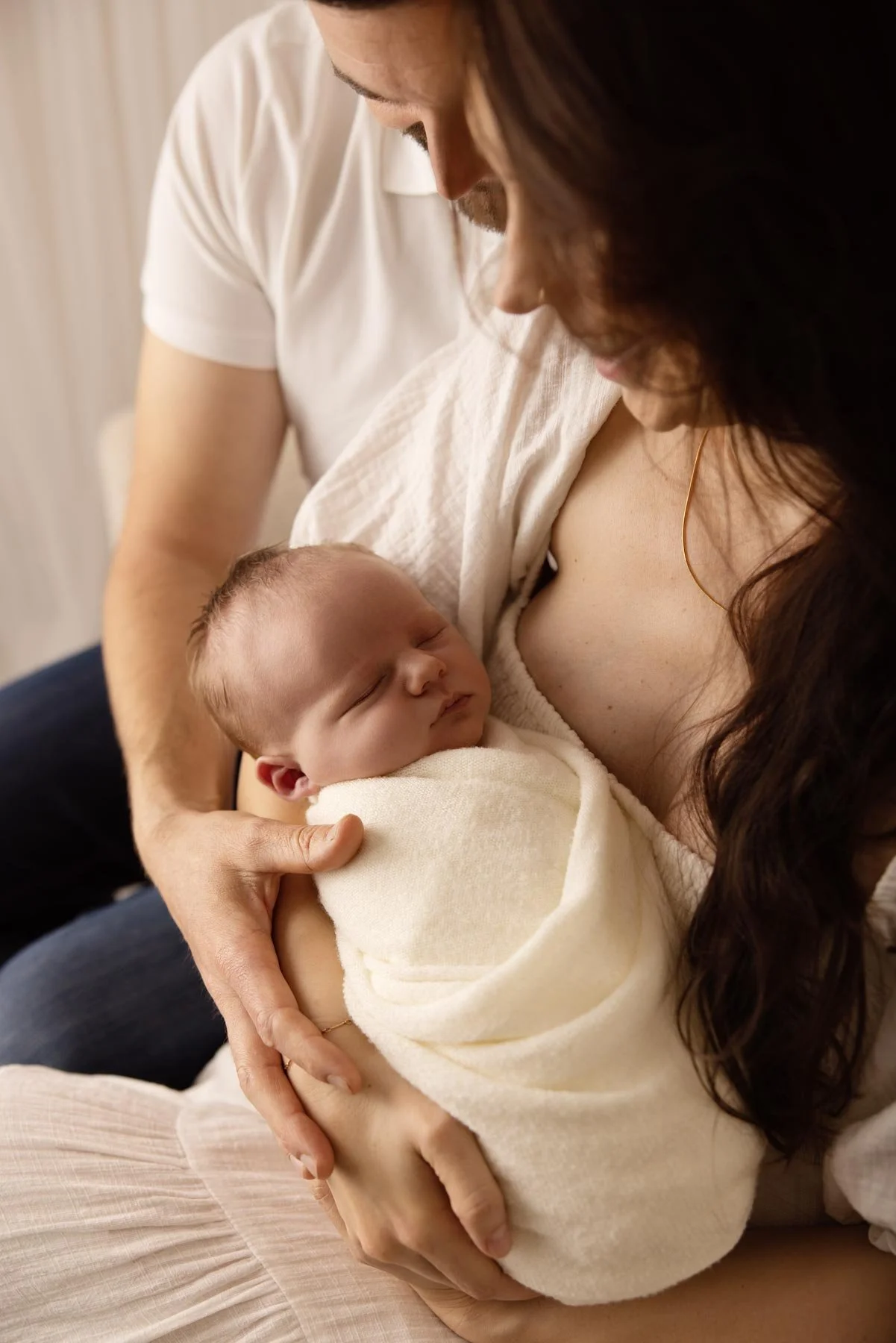 parents holding their newborn baby