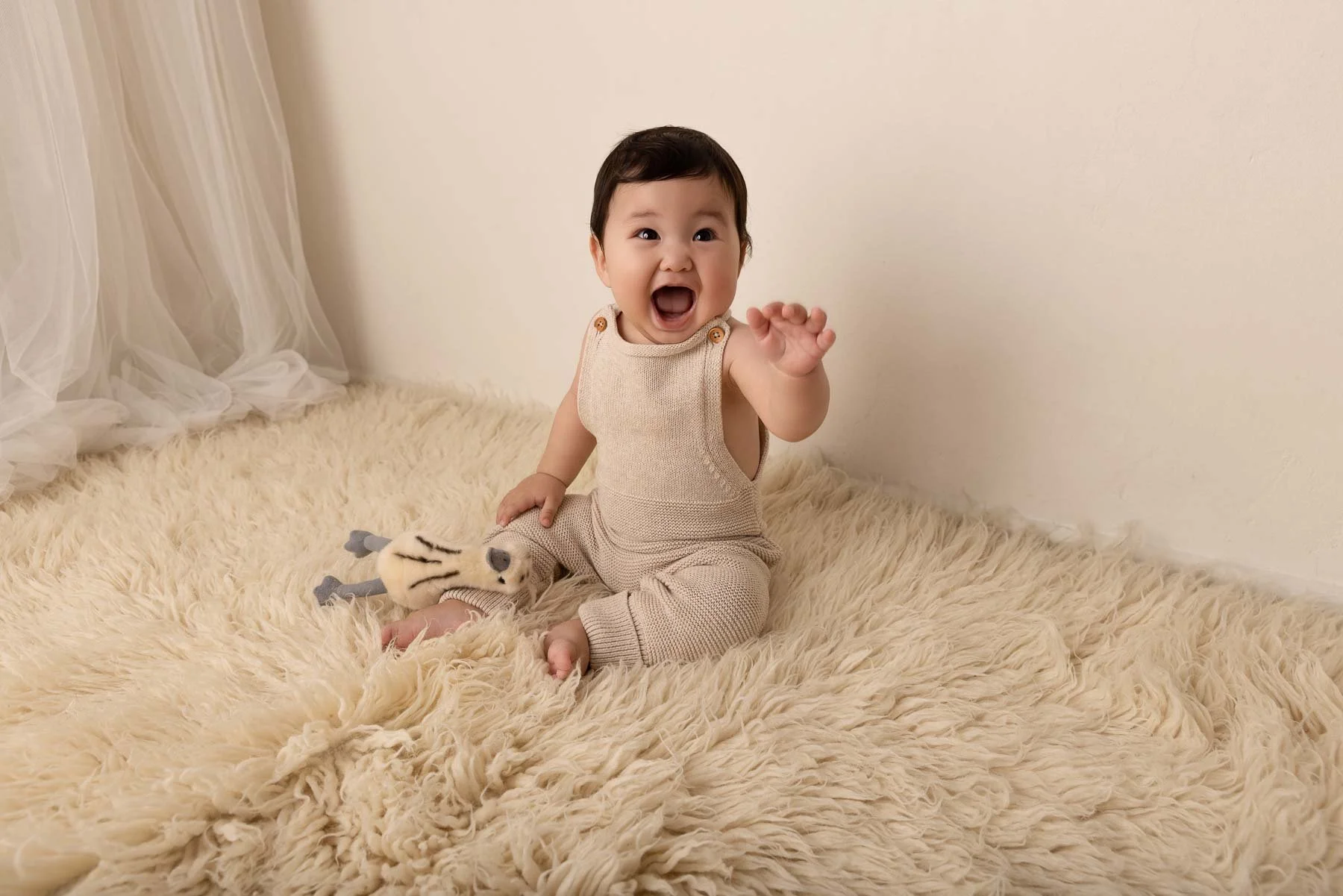 Baby photographer North Shore Sydney earth tones with big smile
