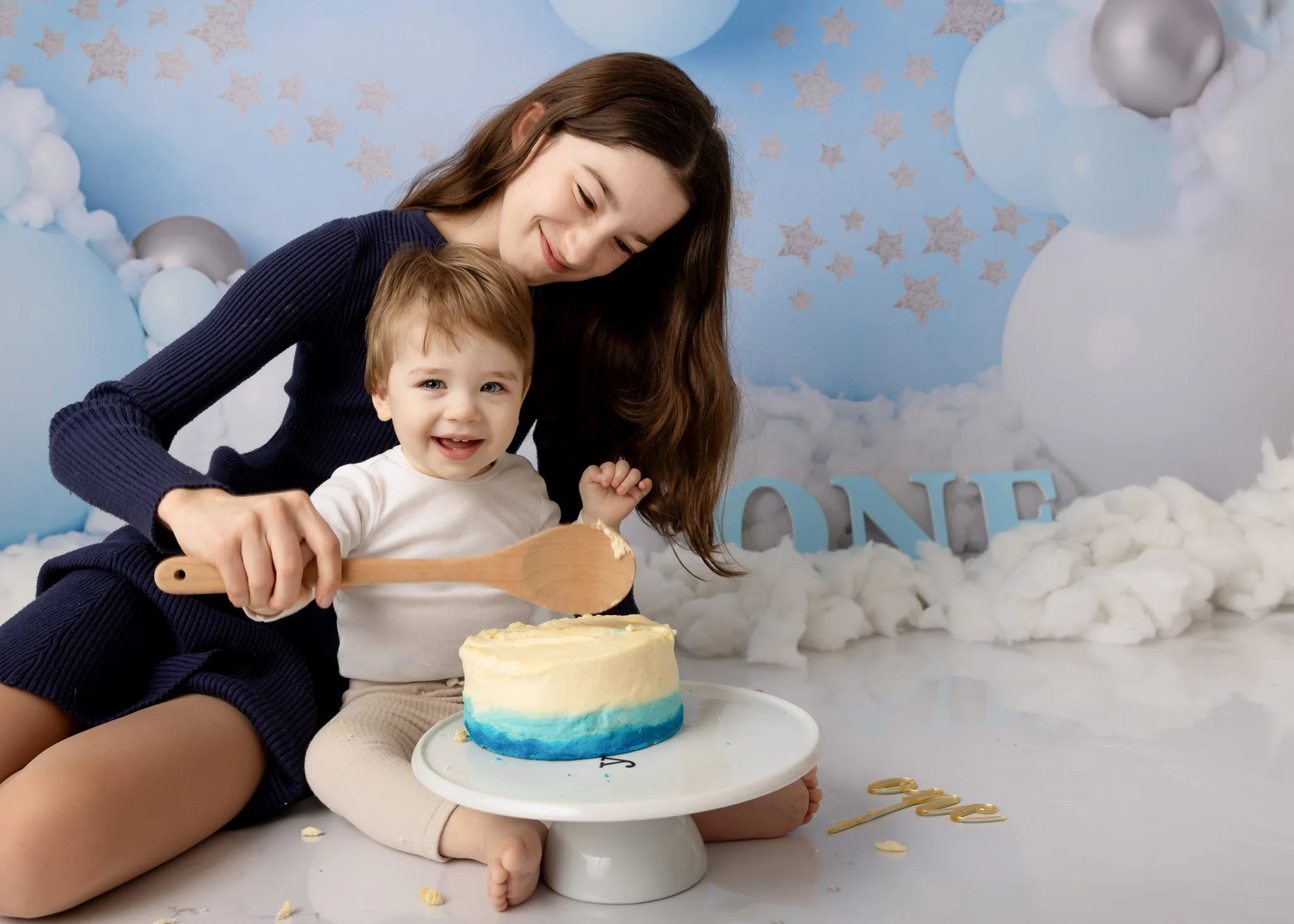 Cake smash photographer Sydney Inner West
baby and his sister laughing with a cake
