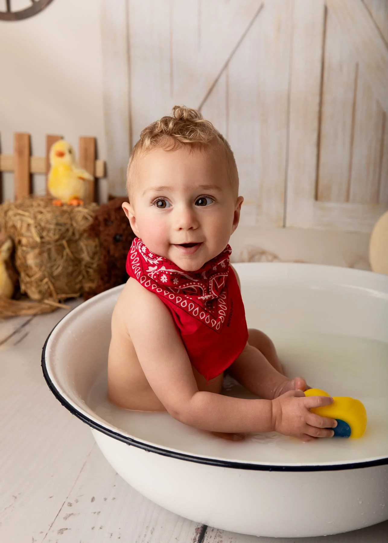 Cake smash photographer Sydney North Shore Farm theme baby boy smiling in a milk bath